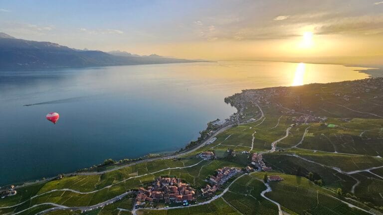 Vue d'une montgolfière au-dessus d'un lac avec coucher de soleile